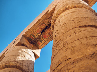 Inscriptions and paintings on ancient columns, close up view. Photographed in Karnak temple in...