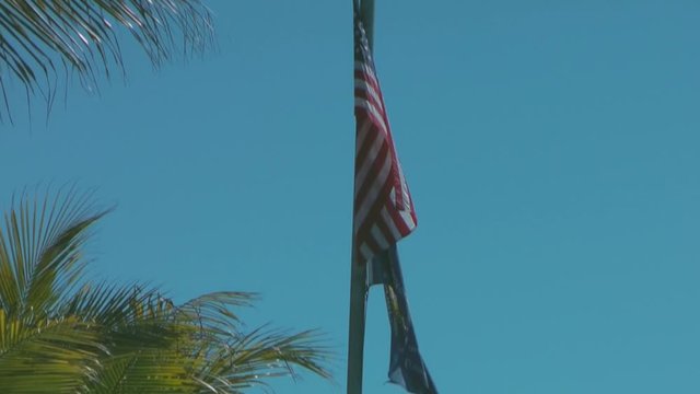 American and the Key West flags flying over Mallory Square in Key West, Florida.