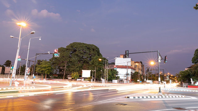 Take photos of the light of a car that runs on the road at night at Maya intersection, Chiang Mai, Thailand