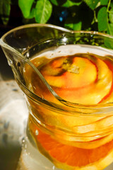 Orange slices in a carafe of water.