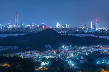 Skyline of downtown of Shenzhen city and rural village of Hong Kong city at night