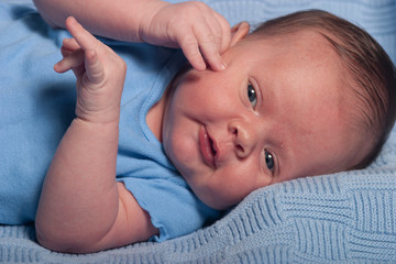 Infant baby boy on a blue blanket