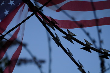 Stacheldraht und Flagge von USA