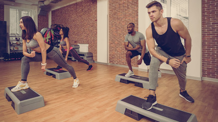 Fototapeta na wymiar Multiracial sporty athletes working together in modern fitness club