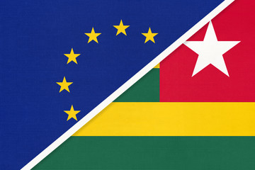 European Union or EU and Togo national flag from textile. Symbol of the Council of Europe association.