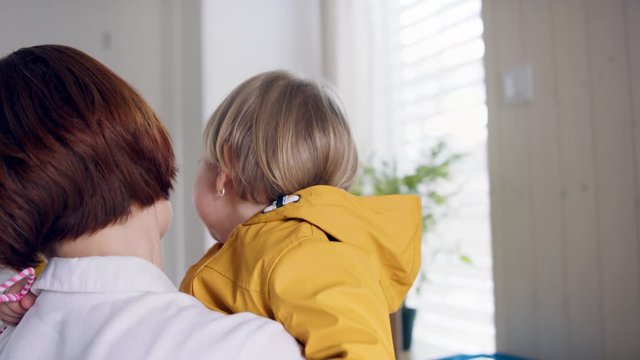 Mother With Small Children In Hall In The Morning At Home, Sibling Rivalry Concept.