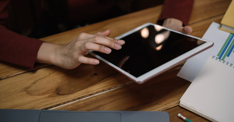 Close up a girl learning online with a tablet at home