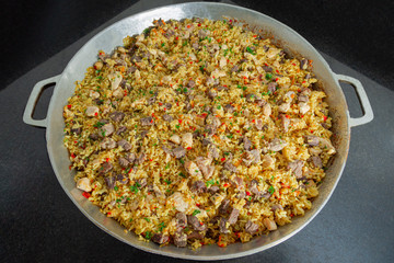 Mixed rice with meat Paella On a rice pot