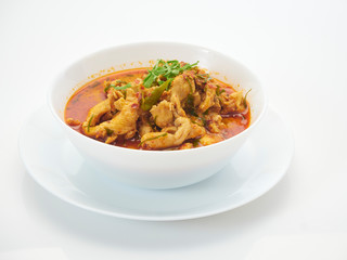 Panang chicken curry in white bowl.