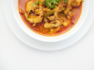 Panang chicken curry in white bowl.