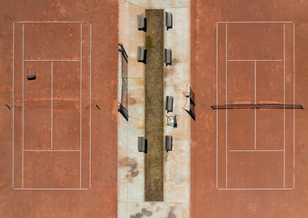 aerial view of two clay tennis courts no people