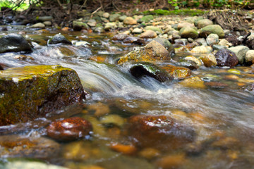 Fototapeta na wymiar motion blur of water stream on rocks