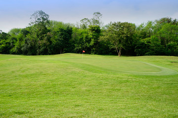 Beautiful golf course in a sunny day. Background evening golf course has sunlight shining down. Golf course in the countryside.