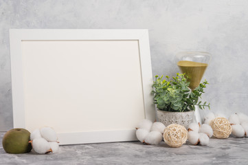 Empty white frame mockup on wall background with design accessories. Concept design and font lettering and image placement