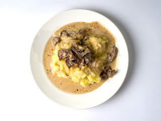 Beef stroganoff with crushed potatoes on a plate. Tasty healthy food