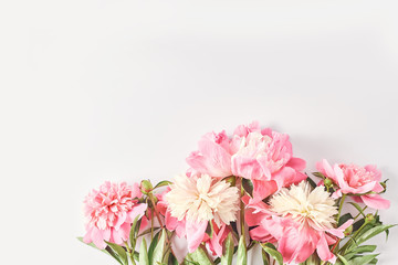 wedding concept. beautiful peonies on a white background. simple layout for an invitation. space for text, flat lay