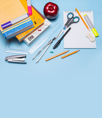 School supplies on a blue background. Back to school! Top view