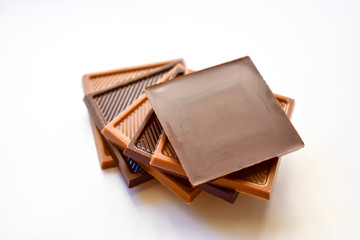 Square shaped milk and dark chocolate isolated on white background