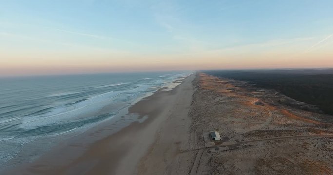 A static top aerial drone shot of the empty beach in le Porge with sight of the horizon