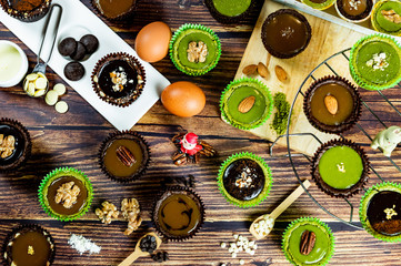 Chocolate Brownie Cake in Paper Cups Decorated with components for making cakes placed on wooden floors