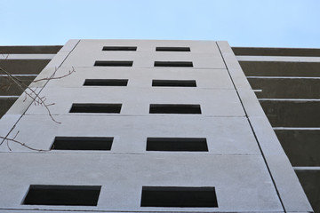 A panel house under construction against the blue sky. Bottom-up shooting.