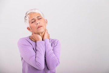 Close up of sad senior lady with neckache. Senior woman with chronic pain syndrome fibromyalgia...