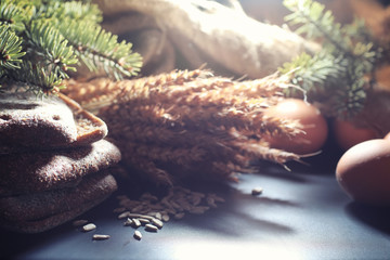 Fresh loaves of bread with wheat and gluten on a black table. Bakery and grocery concept. Fresh, healthy sorts of rye and white loaves food closeup. Fresh homemade bread with cereals.