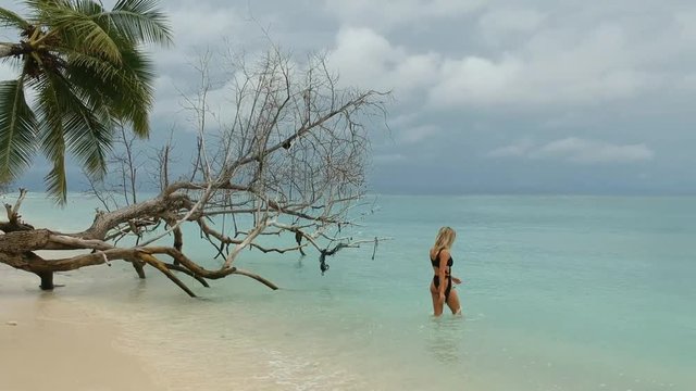 young beautiful woman walking on the beach, Maldives,  thoddoo island.