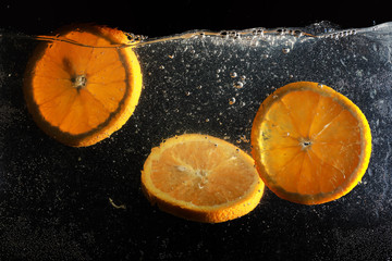 Water drops on ripe sweet orange. Fresh mandarin background with copy space for your text. Vegetarian concept.