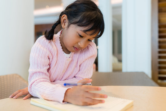 Kid girl draw on book