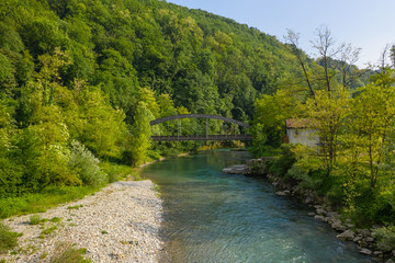 Fototapeta na wymiar Wonderful view of the Serio river and old bridge, Val Seriana Bergamo.