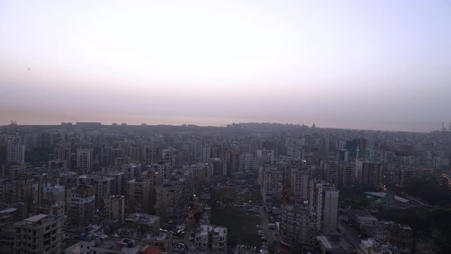 Time lapse: urban city skyline view of buildings from day to night, Tripoli, Lebanon