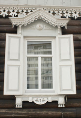 Window with carved wooden shutters in a Russian house