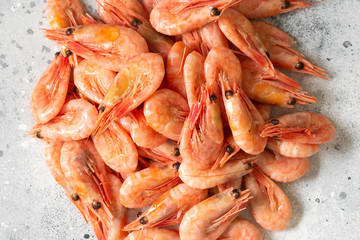 Prawns on a light gray table. Lots of shrimp on the table. Shrimp close-up. The view from the top