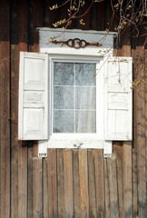 Obraz na płótnie Canvas Window with carved wooden shutters in a Russian house