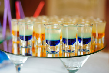 Several colorful alcohol shots on the table
