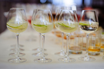 Cold alcohol cocktail with lime,  on the table