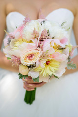 Wedding bouquet with roses in bride hands