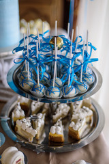 Blue decorated cake pops on the candy bar