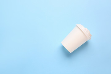 Takeaway cup for drink on color background