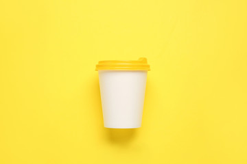 Takeaway cup for drink on color background