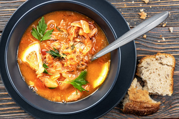 Red soup with vegetables and meat, tasty, appetizing traditional Ukrainian borsch, close-up, top view, shallow depth of field, selective focus. Healthy Home Food Concept