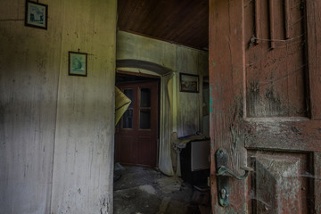 Fototapeta na wymiar open wooden door with a view of an old house