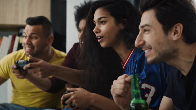Tracking video of excited friends  during playing a game console. Shot with RED helium camera in 8K
