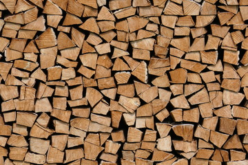 Neatly stacked pile of firewood, wooden structure