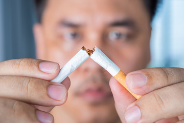 closed up of man hand break cigarette , stop smoking concept