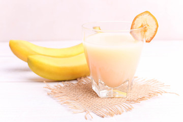 Banana juice in a glass with a slice of banana