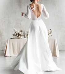 .bride in a white elegant dress. Wedding decor, floral decor. Wedding day. Beautiful young bride. wedding pose