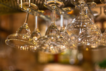 Fototapeta na wymiar Glass goblets in a bar. Glare and light.