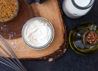Vegetarian mayonnaise. Ingredients for mayonnaise oil, milk and mustard. Homemade mayonnaise